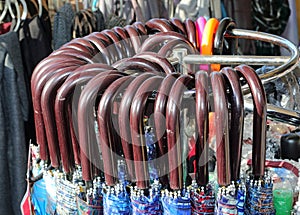 handles of closed umbrellas for sale in the stall of the bazaar photo