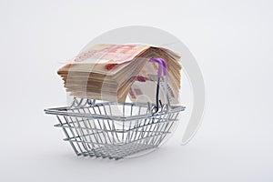 On the handles of the grocery basket is a large bundle of paper Russian five-thousandth bills