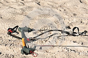 Extreme sport, kiteboard hand bars and cables in sand photo