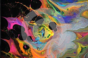 Abstract acrylic pour painting that resembles vibrant neon flames. photo