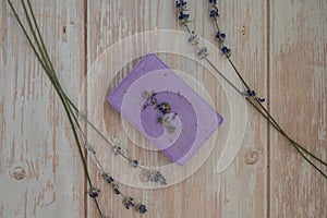 Handmade aromatic spa lavender soap. Natural additives and extracts. Bar of lavender soap with dried flowers. Beauty