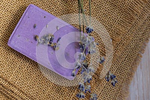 Handmade aromatic spa lavender soap. Natural additives and extracts. Bar of lavender soap with dried flowers. Beauty