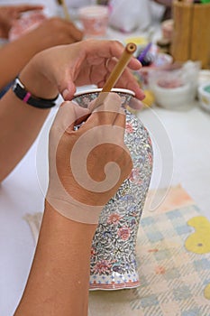 Handmade art of painting porcelain vase using brush