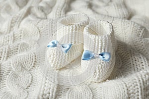 Handmade baby booties on soft knitted