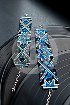 Handmade bead bracelets lie on vinyl records