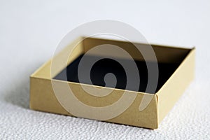 A handmade beige pasteboard box on a white background. Top view