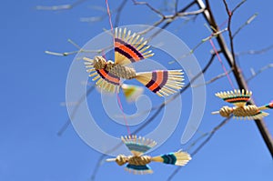 Handmade birds hanging on a tree