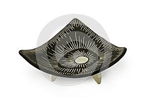 Handmade black glazed ceramic triangular plate with legs isolated on white background