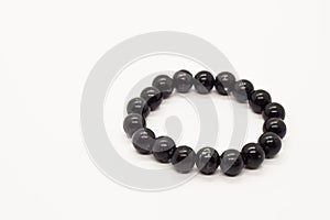 Handmade black onix bracelet on a white background