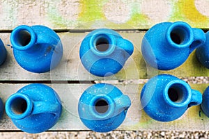 Handmade blue  pitchers on a wooden table. Top view. Close-up