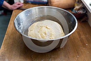 Handmade bread dough rising in a bowl