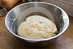 Handmade bread dough rising in a bowl