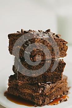 Handmade brownie covered in chocolate sauce photo