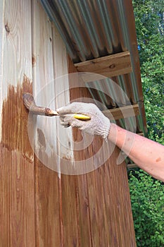 Handmade brush for manual painting on a wooden wall