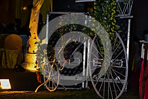 Handmade bycycle with baskets of flowers light focus on bycyle photo