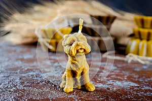 Handmade candle in shape dog made from natural beeswax