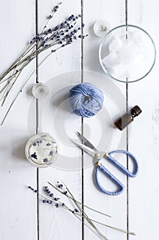 Handmade candles with lavender on wooden background top view