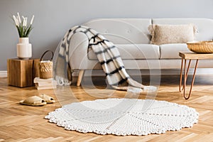 Handmade carpet and grey sofa in boho living room.
