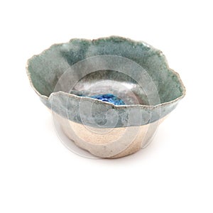 Handmade ceramic pinch pot isolated on a white studio background