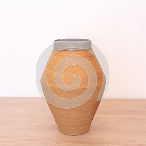 Handmade ceramic vase, white background, red