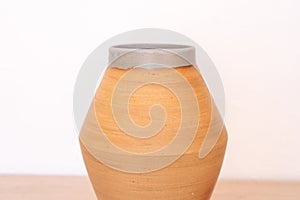 Handmade ceramic vase, white background, red