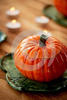 Handmade ceramics in the form of pumpkins.The atmosphere of celebration and home comfort . Cheerful orange pots to the