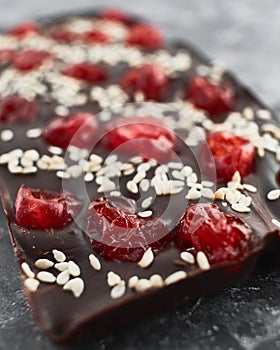 Handmade chocolate bar with cherry and sesame filling.