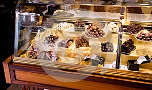 Handmade chocolate display case in a European confectionery, selective focus