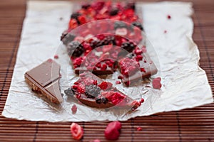 Handmade chocolate with fresh and dried berries, raspberries, strawberries, black currants, blackberries, cocoa powder