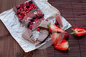 Handmade chocolate with fresh and dried berries, raspberries, strawberries, black currants, blackberries, cocoa powder