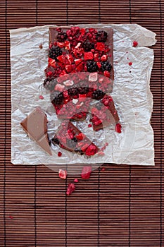 Handmade chocolate with fresh and dried berries, raspberries, strawberries, black currants, blackberries, cocoa powder