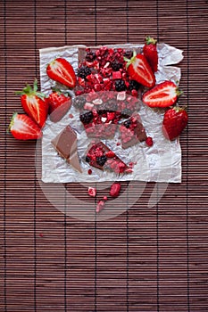 Handmade chocolate with fresh and dried berries, raspberries, strawberries, black currants, blackberries, cocoa powder