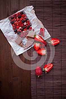 Handmade chocolate with fresh and dried berries, raspberries, strawberries, black currants, blackberries, cocoa powder