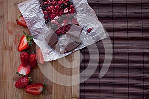 Handmade chocolate with fresh and dried berries, raspberries, strawberries, black currants, blackberries, cocoa powder