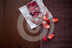Handmade chocolate with fresh and dried berries, raspberries, strawberries, black currants, blackberries, cocoa powder
