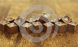 Handmade chocolates on wooden background