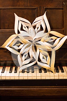 Handmade Christmas paper Star on piano