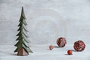 Handmade christmas tree on rustic gray wood table with red baubles