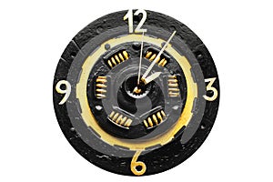 Handmade clock on a white background. A clock from a car clutch disc. Black watch with gold elements