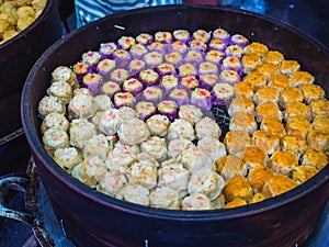 Handmade Colorful Dim Sum with different fillings. Steamed dumplings in many flavors, delicious Malaysia Chinese street food