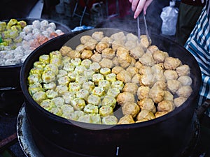 Handmade Colorful Dim Sum with different fillings. Steamed dumplings in many flavors, delicious Malaysia Chinese street food