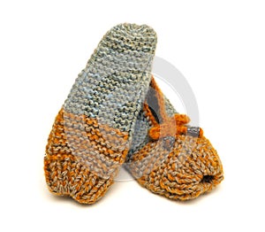 Handmade colorful knitted wool slippers on a white background