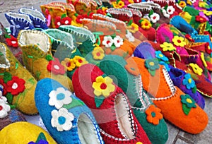 Handmade colorful wool slippers or shoes for sale at street