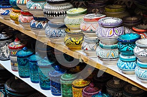 Handmade colourful decorated bowls or cups on display at traditional souk - street market in Morocco