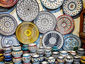 Handmade colourful decorated bowls or cups on display at traditional souk - street market in Morocco