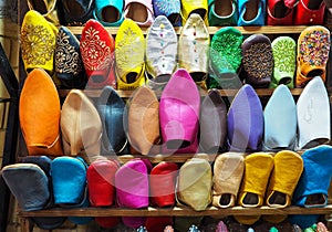 Handmade colourful leather slippers on display at traditional souk - street market in Morocco
