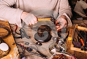 Handmade copper wire working tools on the table with accessoires. handicraft people art concept