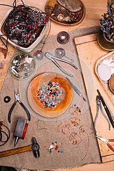 Handmade copper wire working tools on the table with accessoires. handicraft people art concept