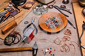 Handmade copper wire working tools on the table with accessoires. handicraft people art concept