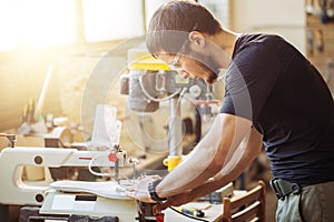 Carpenter engaged in processing wood at the sawmill.